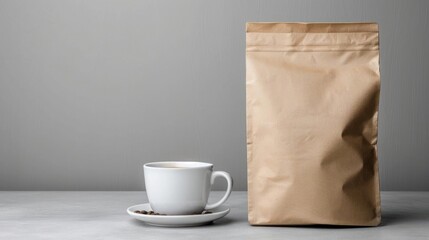 Minimalist composition with a white coffee cup and a brown paper bag on a gray background, perfect for coffee shop or cafe promotions.