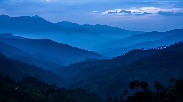 A blue hour landscape shot taken just after sunset in Manipur, India, with the eastern end of the Himalayas visible as a silhouetted structure.