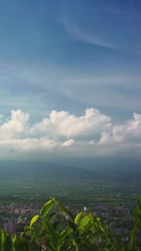 Beautiful white clouds and sky in time lapse with mountains and cityscape view