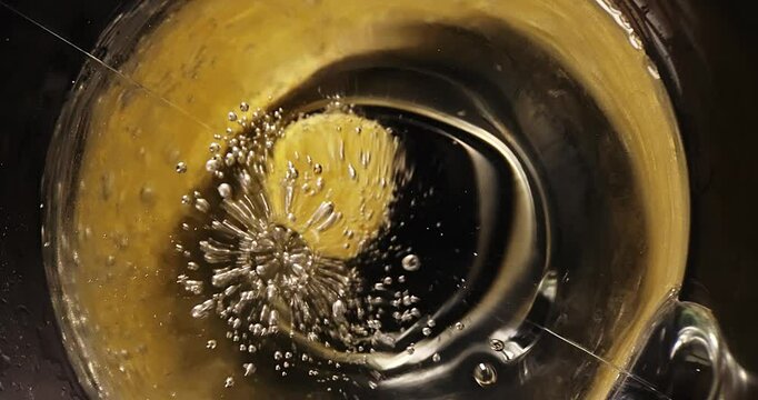 Effervescent soluble tablet falls into water with bubbles close-up in slow motion. Vitamin C, asperin bubbles.