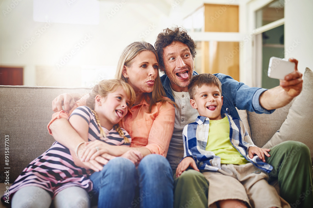 Wall mural Happy family, silly face and sofa with selfie for photography, funny picture or memory together at home. Mother, father and goofy children for bonding, holiday or weekend moment on couch at house