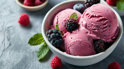 Bowl of frozen berry ice cream with fresh berries and mint. Summertime flavor