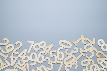 Many wooden numbers scattered at the bottom of gray background