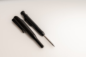 black mechanical pencil and case used for woodworking isolated on a white background