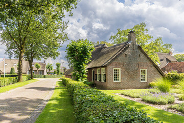Ancient little farm houses with straw roofing in village Norg in Municipality Noordenveld in the...