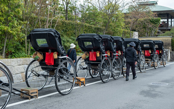 Traditional red hand pulled Indian rickshaw parked on the roadside, Japan.