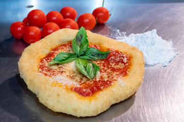 Neapolitan fried pizza with tomato sauce cheese and basil leaves, called Montanara