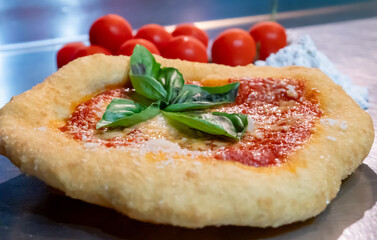 Neapolitan fried pizza with tomato sauce cheese and basil leaves, called Montanara