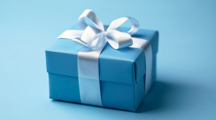 Obraz premium Blue gift box wrapped with a white ribbon, conveying a sense of elegance and anticipation on a minimalist blue background