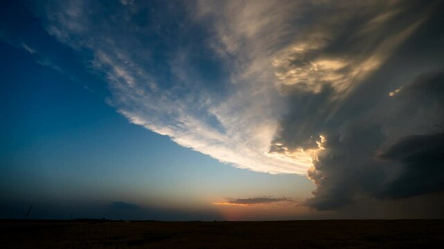  Sun sets over fields of wheat as storm clouds fill with beautiful color