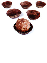 Traditional Brazilian sweet known as brigadeiro or Brazilian truffle and some empty packaging on background with copy space
