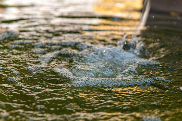 body of water with a stream of water coming out of it