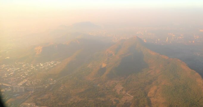Shil Phata - Mahape Rd, MIDC Industrial Area, Mahape, Navi Mumbai, Maharashtra, India. Mumbai Metropolitan Region. Aerial View From Airplane Window On View of the Mumbai suburb district. Evening