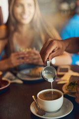 Person, pour and milk in coffee at cafe with latte art, creative and pattern process of barista for breakfast caffeine. Warm, beverage and expresso with cream for drawing design, foam and restaurant