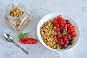 a bowl of granola with fresh raspberry and red currant top view 