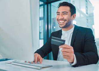 Fototapeta premium Business, man and credit card with computer in office for online shopping, ecommerce or happy with payment. Professional, trader or employee with cryptocurrency investment, fintech or banking at desk