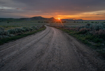 Setting sun over a road in the Big Muddy Valley at Castle Butte in Saskatchewan