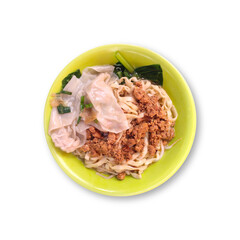 A bowl of chicken noodles or Bakmi Ayam in Indonesian topped with minced chicken, chicken dumplings and vegetables isolated on white background