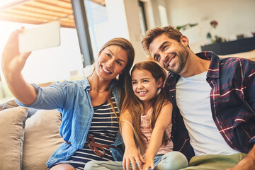 Happy, girl and family selfie on sofa with bonding time, relax together and memory for photo album in home. Smile, daughter and parents with profile picture for blog, love and relationship on couch