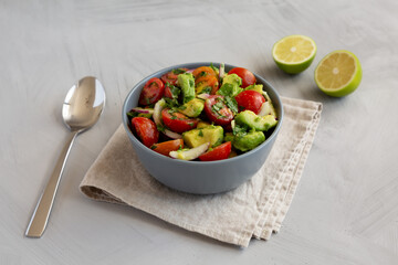 Healthy Organic Avocado And Tomato Salad in a Bowl, side view.