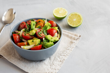 Homemade Avocado And Tomato Salad in a Bowl, side view.