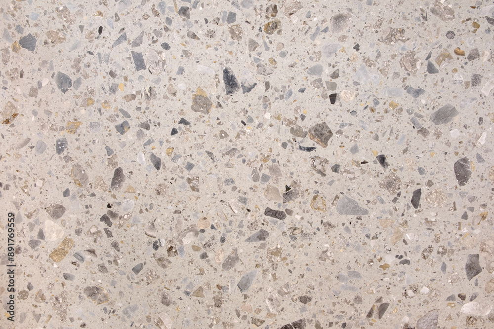 Poster A white and gray stone surface with many small stones scattered across it. The surface appears to be a mosaic or a tiled floor