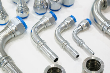 A collection of different types of metal pipes and fittings. The pipes are silver and blue. The...