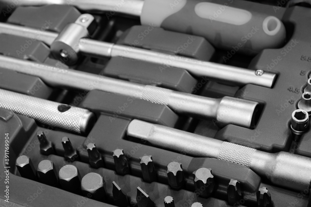 Poster A toolbox with many different tools including a wrench. The wrench is silver and has a black handle