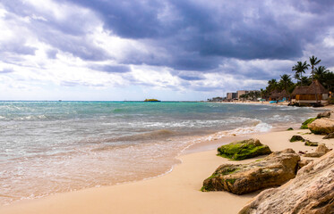 Tropical Caribbean beach huts cottages parasols resort Playa del Carmen.