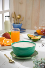 Oatmeal, healthy food item  arranged on wooden background in a ceramic bowl.