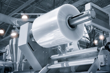 Automatic polyethylene plastic bag production machine with lighting effect. Close-up of the roller...