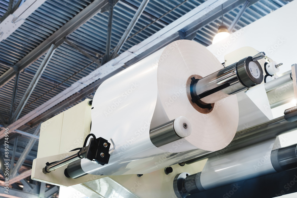 Poster automatic polyethylene plastic bag production machine with lighting effect. close-up of the roller o