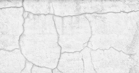 A wall with cracks and holes in it. The wall appears to be old and worn down