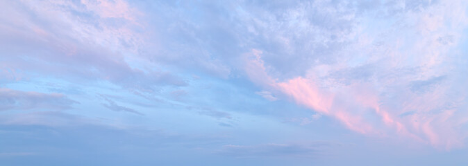A beautiful blue sky with pink clouds. The sky is a perfect backdrop for a beautiful sunset
