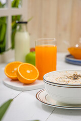 Oatmeal, healthy food item  arranged on wooden background in a ceramic bowl.