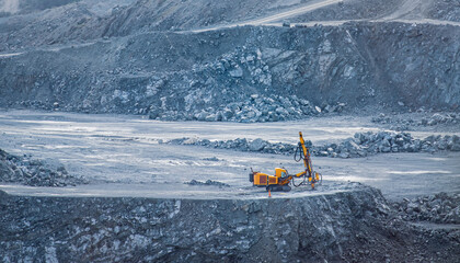 Drilling machine in diabase quarry with rocky terrain. Parekklisia quarry, Cyprus