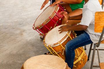 A person playing a traditional instrument of the African culture.