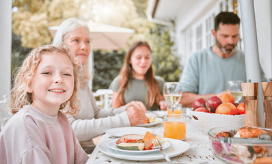 Kid, portrait and family with lunch outdoor for holiday celebration, brunch or eating food with bonding. Girl child, people and dinner event on patio in festive season with relax, nutrition or happy