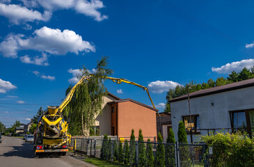 A concrete mixer feeds concrete into the screed when building a house