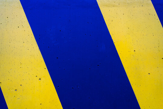 Cement wall with yellow and blue color.