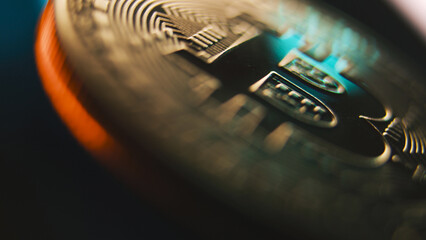 Close up of spinning gold bitcoin coin. Digital cryptocurrency virtual money. Blockchain modern technology. P2P BTC crypto trading. Peer-to-peer payment system. Finance, investment and E-commerce.