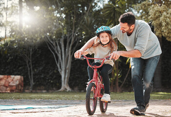 Father, daughter and learning with ride on bicycle for teaching, lesson or practice at outdoor...