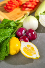 A variety of appetizing fresh vegetables are meticulously arranged on the kitchen counter