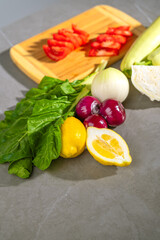 Fresh Vegetables and Fruits - Lemons, Onions, Tomatoes on Cutting Board