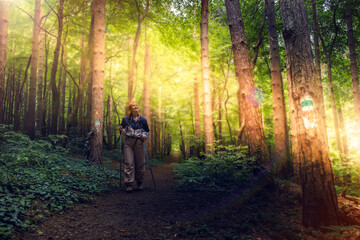 Obraz premium Beautiful young women with big backpack hiking in the deep forest