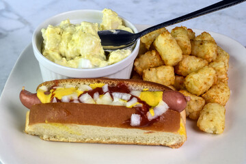 hot dog with tater tots and potato salad