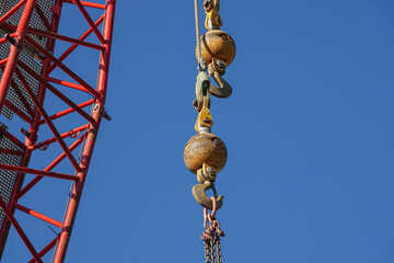 Fototapeta premium construction crane hook against blue sky background