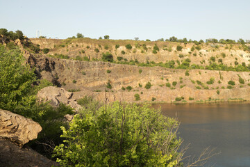 Rocky quarry lake shore in summer
