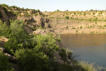 Rocky quarry lake shore in summer