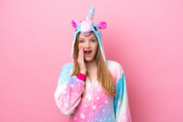 Teenager Russian girl with unicorn pajamas isolated on pink background with surprise and shocked facial expression